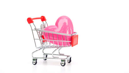 Pink heart in a shopping cart on a white background.の写真素材