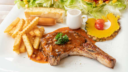 Pork Chop steak on a white plate.の写真素材