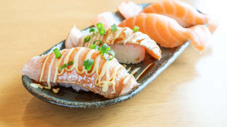 Fresh salmon sushi on a wooden table.の写真素材
