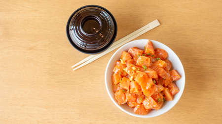 Fresh spicy salmon and rice on a wooden table.の写真素材
