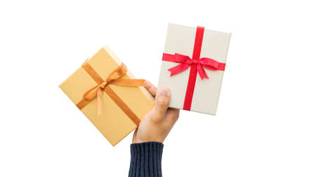 Man holding a gold and silver gift box on a white background.の写真素材