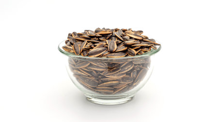 Sunflower seed in a bowl on a white background.の写真素材