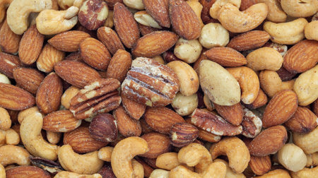 Close up of baked mixed nuts for a background.の写真素材