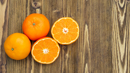 Orange fruit on a wooden table.の写真素材