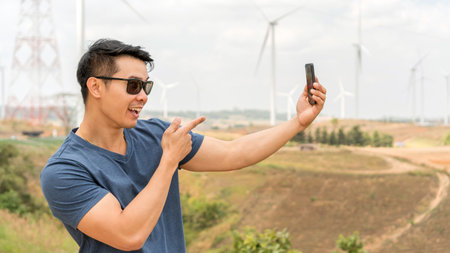 Asian young man using a telephone at a mountain.の写真素材