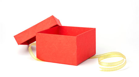 Red gift box and gold ribbon on a white background.の写真素材