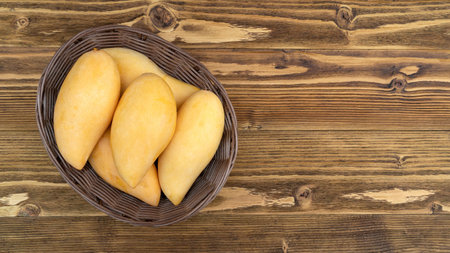 Ripe mango on a wooden table.の写真素材