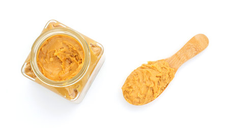 Peanut butter in a spoon and bottle on a white background.の写真素材