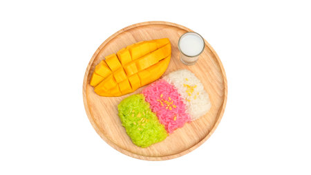 Three colors of sticky rice and ripe mango (Thai dessert) on a white background.の写真素材