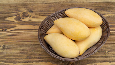 Ripe mango on a wooden table.の写真素材
