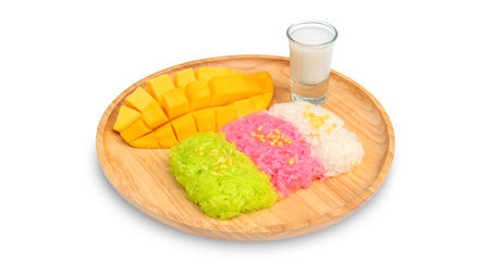 Three colors of sticky rice and ripe mango (Thai dessert) on a white background.の写真素材