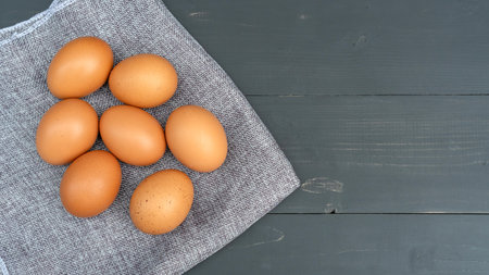 Chicken egg on a black wooden table.