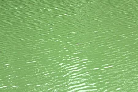 Water surface with reflection of sunbeamの写真素材