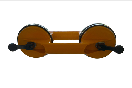 Yellow Dual Cup Suction Lifter isolated on the glassの写真素材