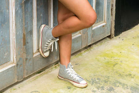 close up of legs women with sneakers shoe