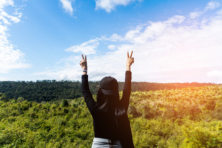 woman stand on mountain with beautiful blue sky. subject is blurredの写真素材