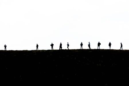 silhouette group of hiking on mountain with white background, subject is blurred