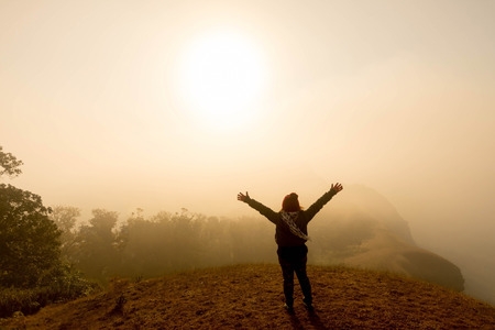 happy woman smile on top mountain with blue sky at sunny day, subject is soft focusの写真素材