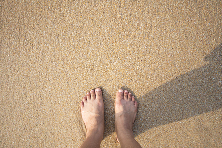 foot of human on sand and soft wave on the sea. soft focusの写真素材