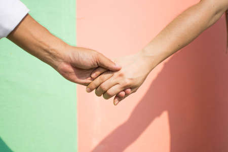 hand of couple love with colorful background. subject is blurred.の写真素材