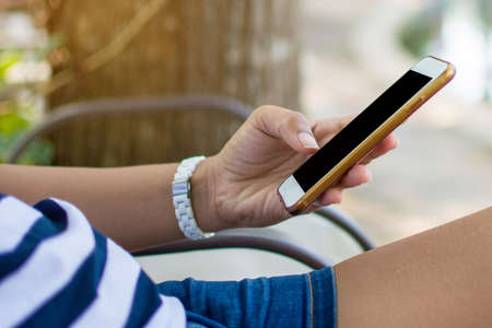 people hand holding smart phone and use device technology. subject is blurred.の写真素材