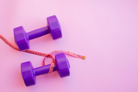 Fitness equipment dumbbells on color background. Flat lay.の写真素材