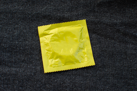 Condom on black jeans pocket with World Aids day concept.の写真素材
