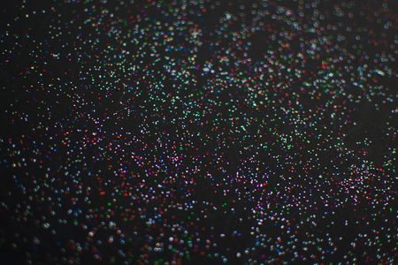 blur of glitter on black background.の写真素材