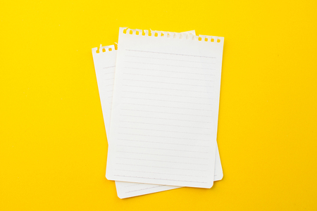 empty paper of notebook on yellow background with school concept.の写真素材