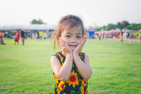 happy little girl run and playing in the park. soft focus.の写真素材