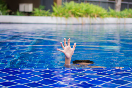 cute little boy feel happy play and swimming at swimming pool , sunny day and soft focus.の写真素材
