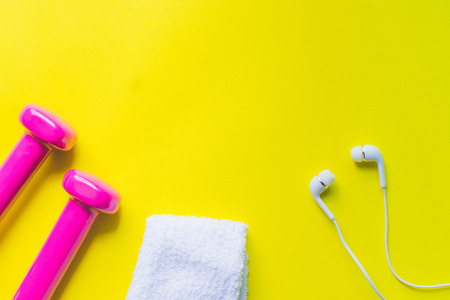 Fitness background, Equipment for gym and home dumbbell and Sneakers, earphone on color background....