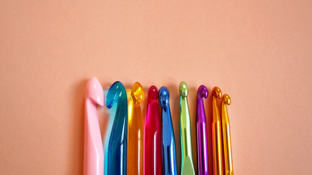 Colorful Crochet Hooks on Orange Backgroundの写真素材