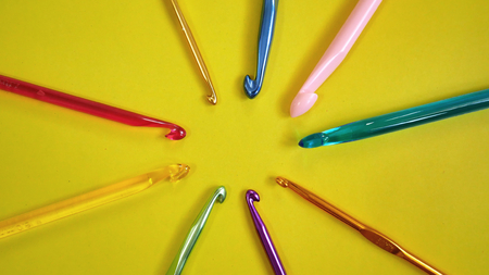 Colorful Crochet Hooks on Yellow Backgroundの写真素材