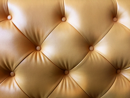 Gold Synthetic Leather Couch with Buttons Textureの写真素材