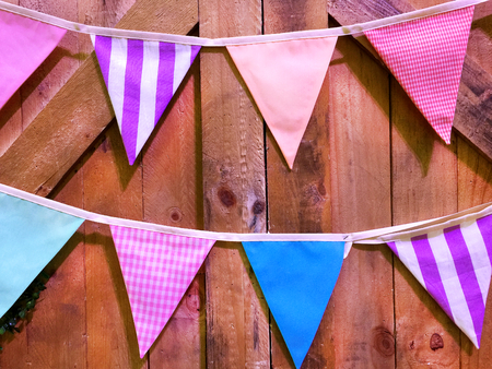 Various Patterned Triangular Flags on Wooden Planks Backgroundの写真素材