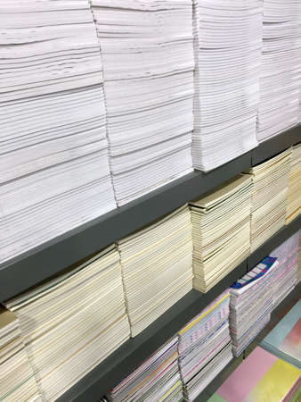 Stacked Notebooks on Shelvesの写真素材