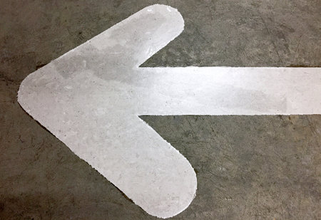 White Arrow Direction Sign on Roadの写真素材