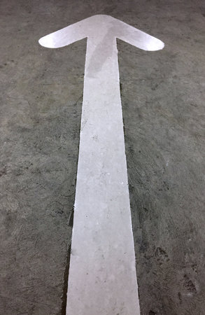 White Arrow Directional Sign Painted on the Roadの写真素材