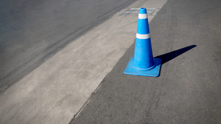 Single Blue Traffic Road Cone with White Stripe on the Streetの写真素材