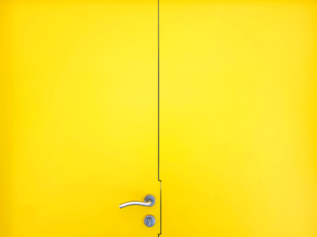 Full Frame Background of Yellow Door with Metal Handle