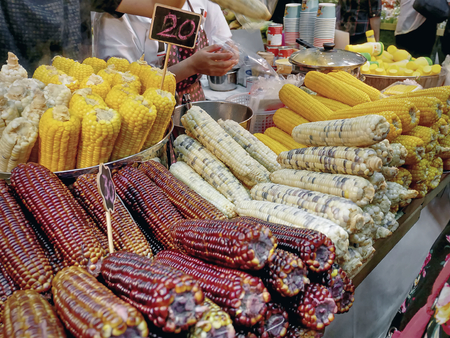 Various Kinds of Boiled Colorful Sweet Corns at the Market with Selective Focus