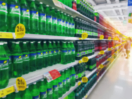 Blurred Background of Soft Drink Bottles on Shelves at Retailed Storeの写真素材