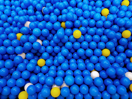 Full Frame Background of Blue Yellow and White Plastic Balls for Kidsの写真素材