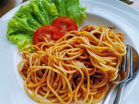 High Angle View of Spaghetti with Sliced Tomatoesの写真素材