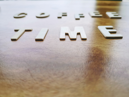 Blurred Background of Wooden Alphabets Coffee Time Word with Selective Focusの写真素材