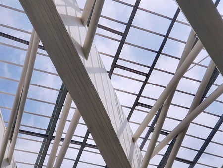 Modern Roof Structure Against Blue Cloudy Sky