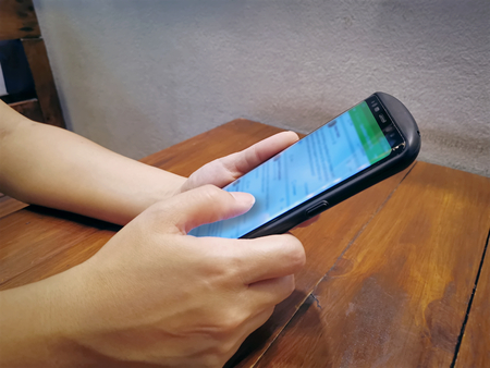 Hand Gesturing on Mobile Phone Screen of Social Network App