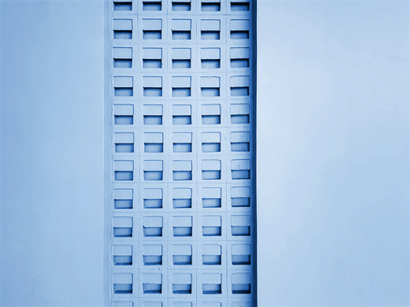 Blue Wall with Multiple Rows of Air Ventilation Holesの写真素材