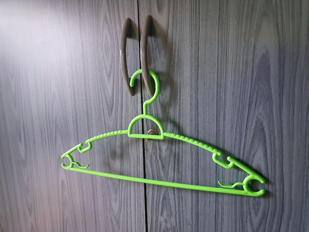 Close-up Green Plastic Cloth Hanger at the Closetの写真素材